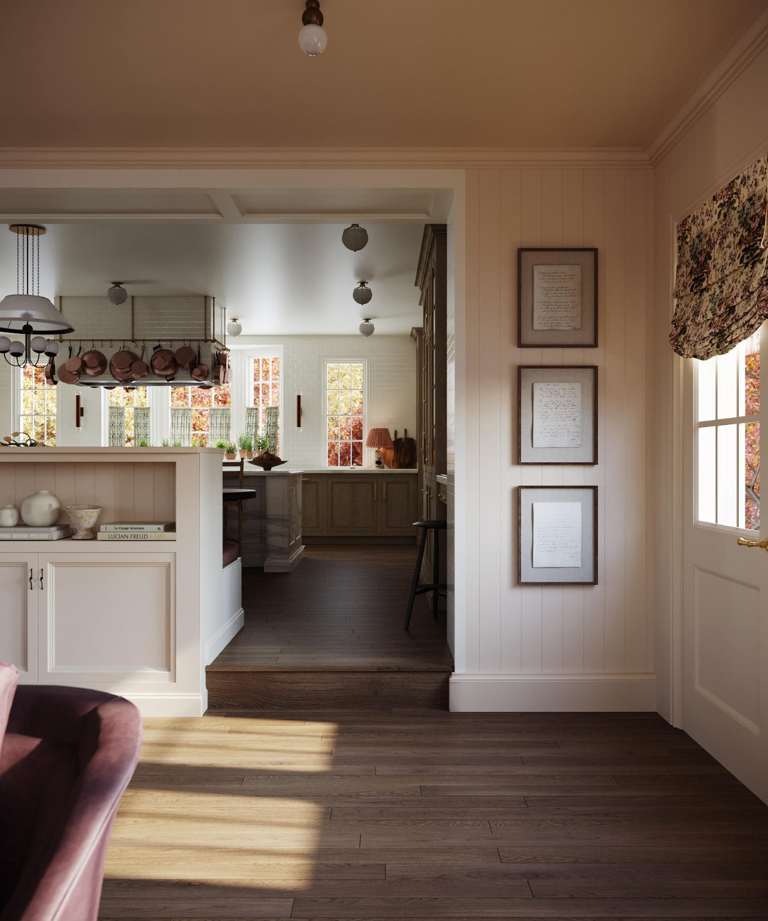 Living room with a view into a kitchen, featuring framed pictures on the wall.